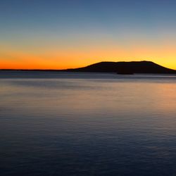 Scenic view of sea against romantic sky at sunset