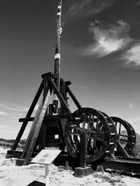 Traditional windmill on field against sky