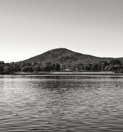 Scenic view of lake and mountains against clear sky