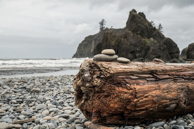 Close-up of rocks on beach against sky