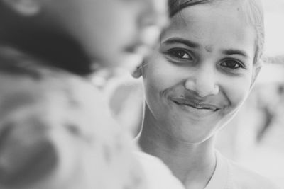 Close-up portrait of smiling woman outdoors