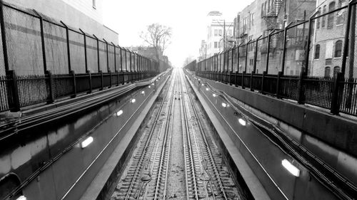 Railroad tracks amidst buildings