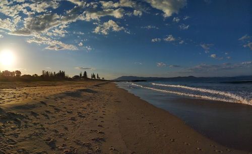 Scenic view of beach against sky during sunset