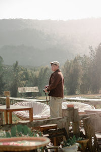 Asian man standing on beautiful terrace and beautiful view of rural resorts in thailand northeast