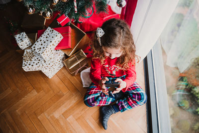 Girl using mobile phone while sitting at home