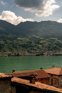 Scenic view of lake by buildings against sky