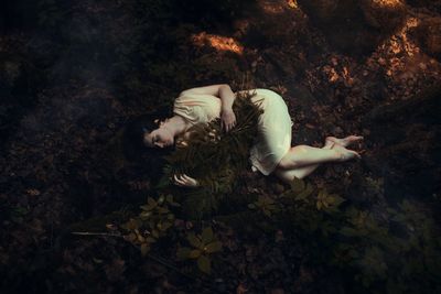 High angle view of woman lying on field at night