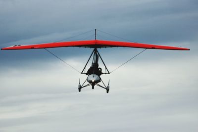 Low angle view of airplane flying against sky