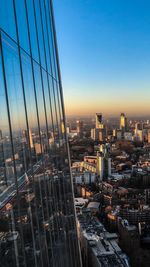 Aerial view of buildings in city during sunset