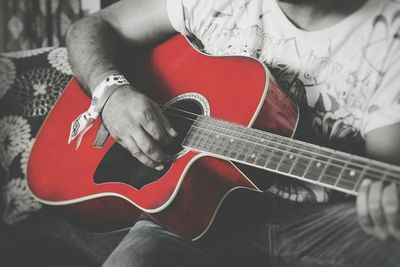 Close-up of man playing guitar