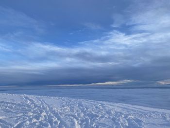 Scenic view of snowcapped mountains against blue sky