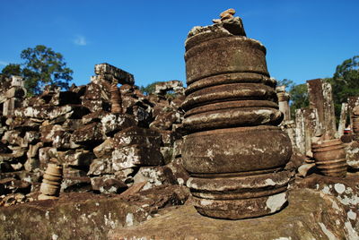 Low angle view of stack of rocks against clear sky