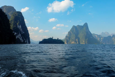 Scenic view of sea and mountains against sky