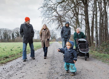 Multi-generation family walking on dirt road