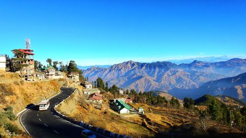 Panoramic view of mountains against clear blue sky