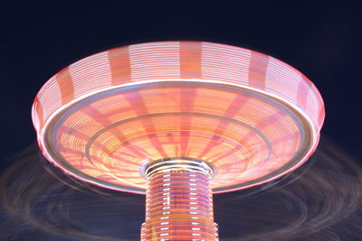 Illuminated ferris wheel against sky at night
