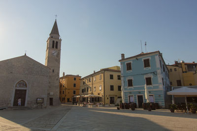 View of buildings in town against clear sky