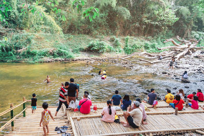 Group of people enjoying by river