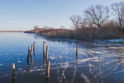 Scenic view of frozen lake against sky during winter