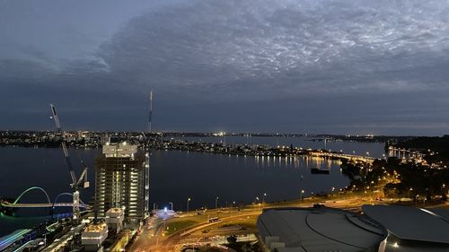 High angle view of illuminated city against sky at night