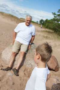 Grandfather with grandson at beach
