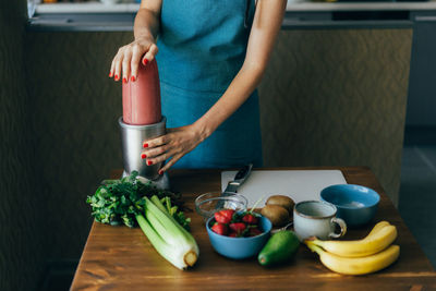 Midsection of woman standing on table