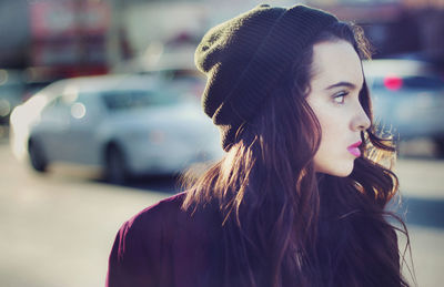 Close-up of woman looking away in city