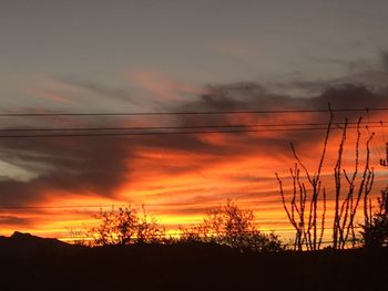 Silhouette landscape against scenic sky