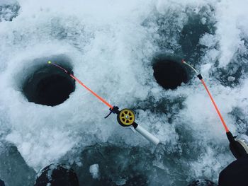 High angle view of fishing rods on frozen lake