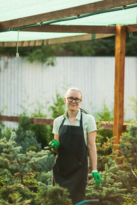 Full length of woman standing by plants