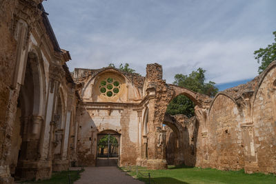 Archway of historic building against sky