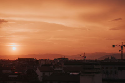 Silhouette buildings against sky during sunset