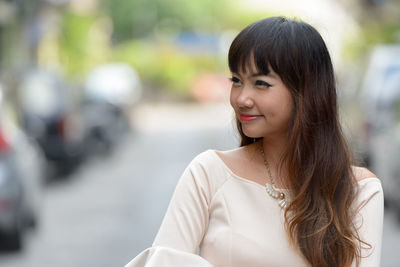 Portrait of smiling young woman outdoors