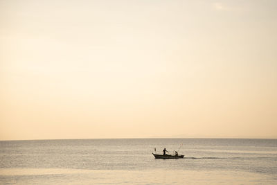 Silhouette boat in sea against sky during sunset