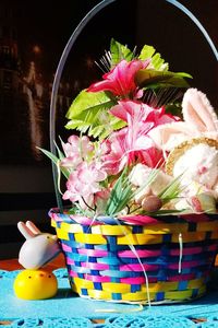 Close-up of multi colored flowers in basket on table