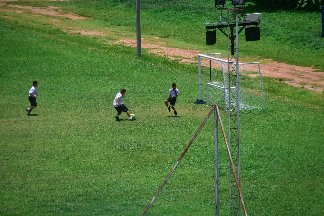 GROUP OF PEOPLE PLAYING SOCCER FIELD