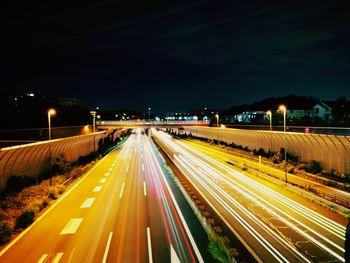 High angle view of light trails on highway at night