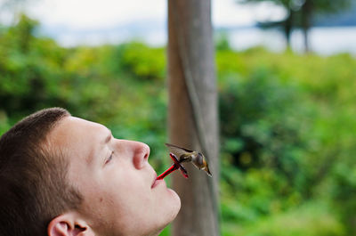 Close-up of man with bird