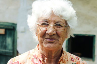 Close-up portrait of senior woman wearing eyeglasses