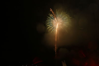 Low angle view of firework display at night