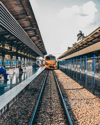 Train at railroad station against sky