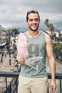 Portrait of smiling man standing in city