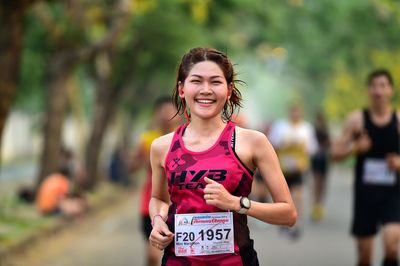 Portrait of a smiling young woman running