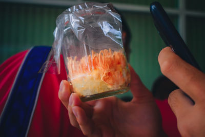 Close-up of hand holding ice cream