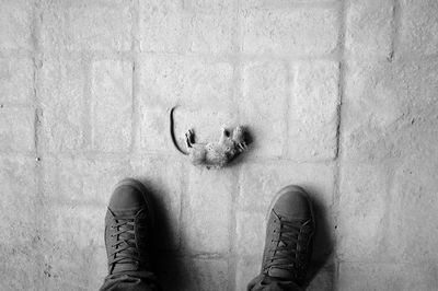 Low section of person standing against wall