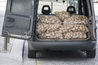 Potato sacks in vehicle on street