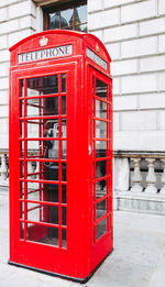 Red telephone booth on wall