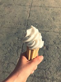 Close-up of hand holding ice cream cone