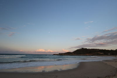 Scenic view of beach against sky during sunset