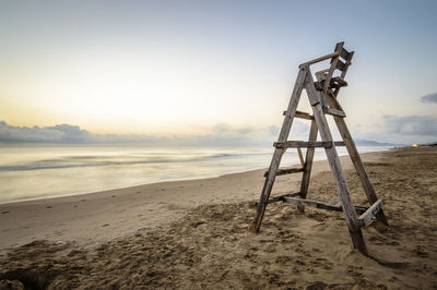 Lookout tower on beach against sky